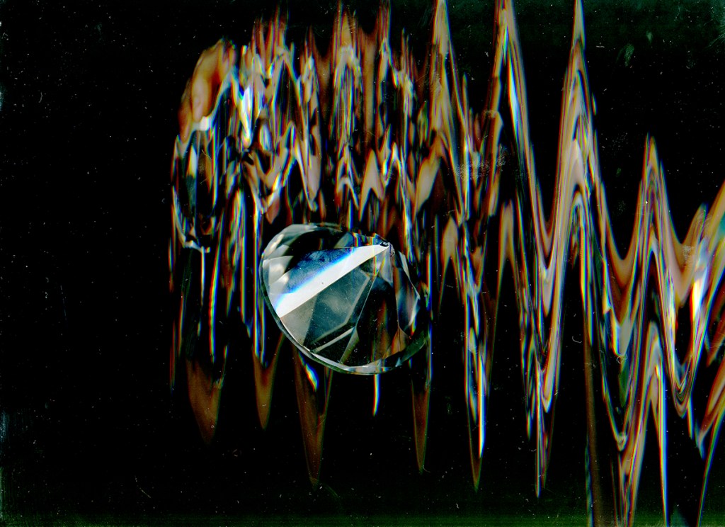 Here is the alt text for the image: "Two glass marbles on a reflective surface, with a distorted and abstract background."